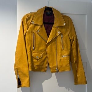 Women’s faux leather yellow jacket with silver zippers
